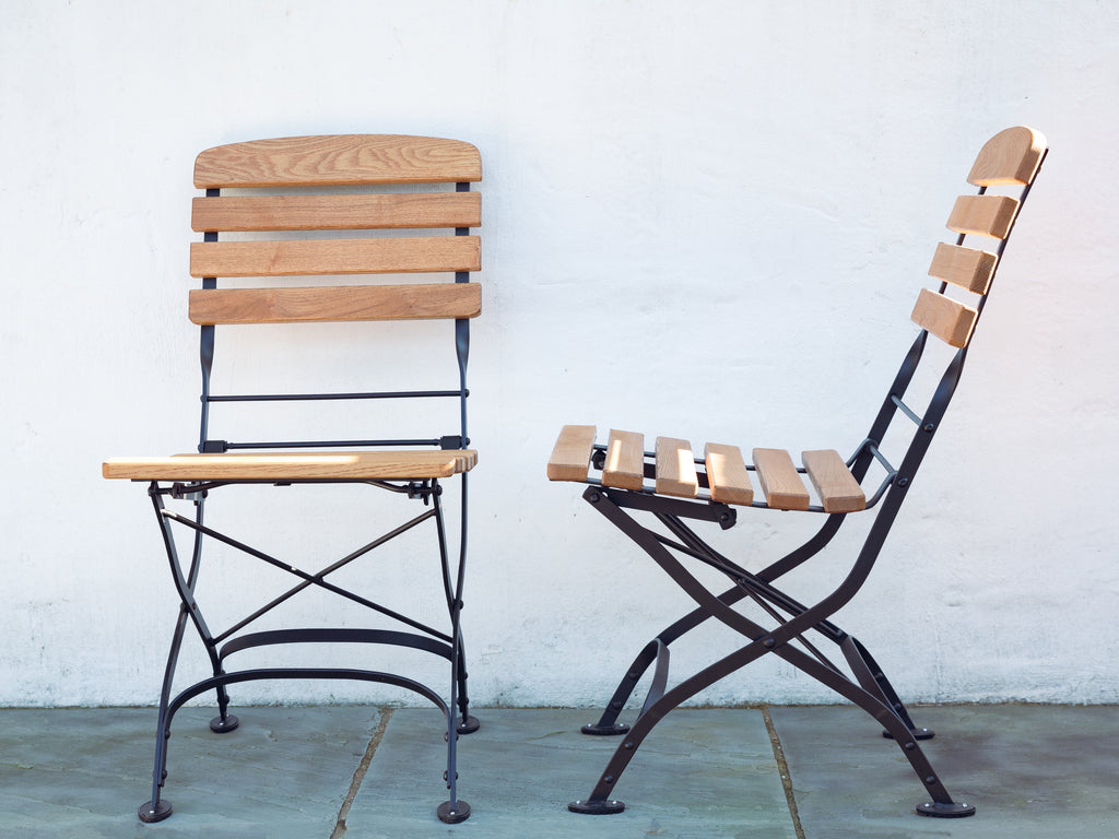 Foldable garden side chair. Sustainable hardwood and matt black steel frame. side angle and front on. 